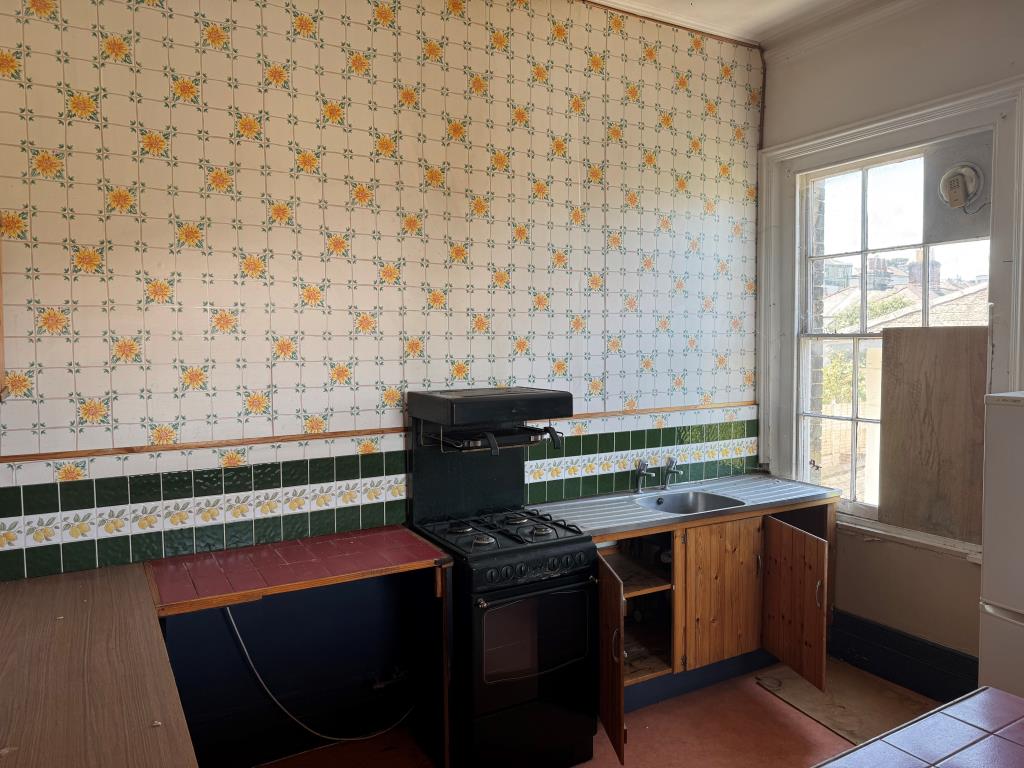 Lot: 47 - TWO STOREY THREE-BEDROOM FLAT FOR IMPROVEMENT WITH STUNNING SEA VIEWS AND PLANNING FOR SPLITTING IF PREFERRED - The Kitchen in Flat Five